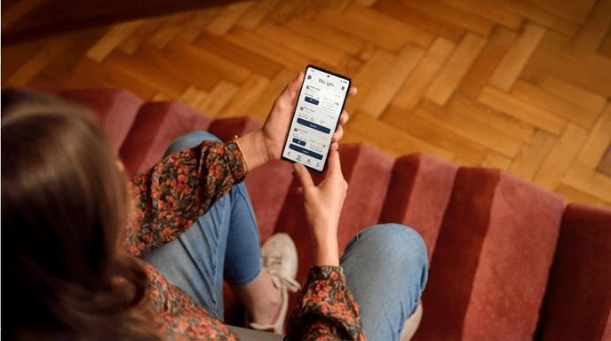 Person using an education app on a smartphone while seated indoors